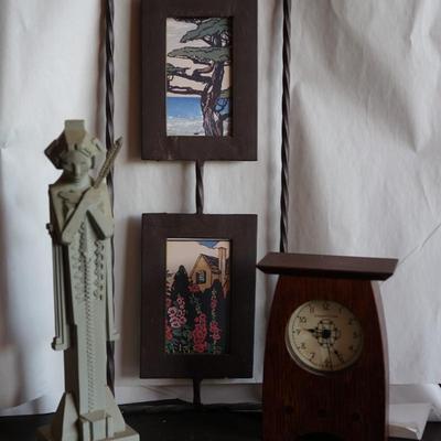 INTHE PRAIRIE STYLE. TWO FRAMED PAPER PRINTS IN BLACK FRAMES WITH WROUGHT IRON HANGER. FLW STYLE STATURE OF 8" & CLOCK FROM THE...