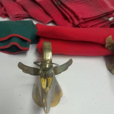 Brass angel napkin rings, with red and green linen napkins