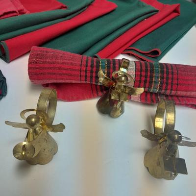 Brass angel napkin rings, with red and green linen napkins