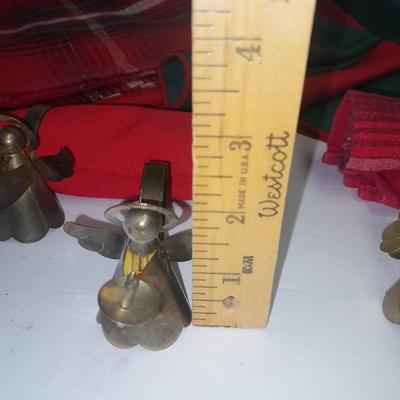 Brass angel napkin rings, with red and green linen napkins