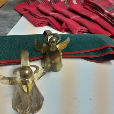 Brass angel napkin rings, with red and green linen napkins