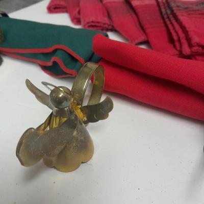 Brass angel napkin rings, with red and green linen napkins