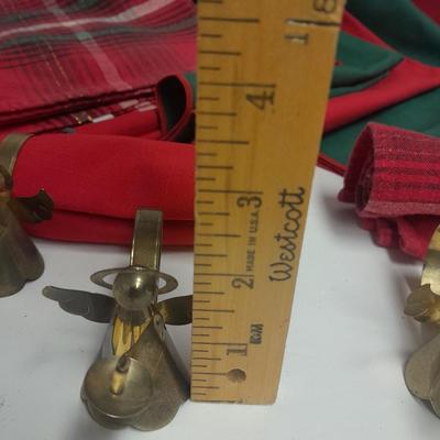 Brass angel napkin rings, with red and green linen napkins