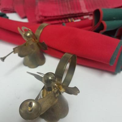Brass angel napkin rings, with red and green linen napkins
