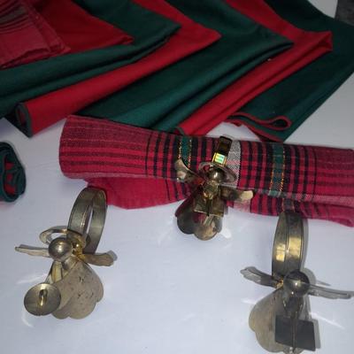 Brass angel napkin rings, with red and green linen napkins
