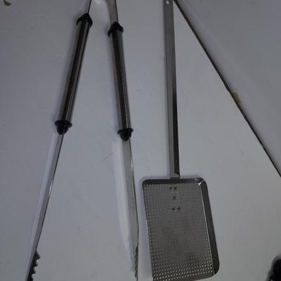 Large stainless steel cooking utensils Barbeque grill or firepit and condiment containers
