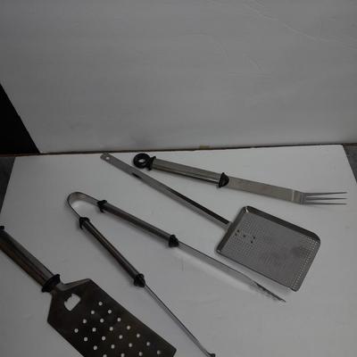 Large stainless steel cooking utensils Barbeque grill or firepit and condiment containers