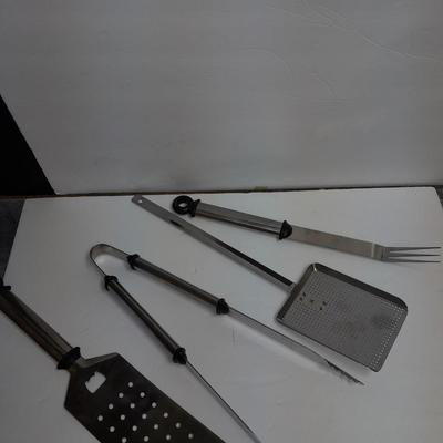 Large stainless steel cooking utensils Barbeque grill or firepit and condiment containers