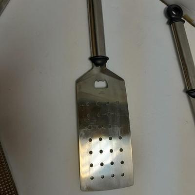 Large stainless steel cooking utensils Barbeque grill or firepit and condiment containers