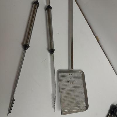 Large stainless steel cooking utensils Barbeque grill or firepit and condiment containers