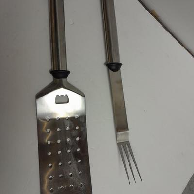 Large stainless steel cooking utensils Barbeque grill or firepit and condiment containers