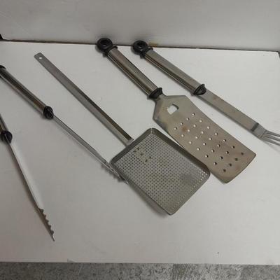 Large stainless steel cooking utensils Barbeque grill or firepit and condiment containers