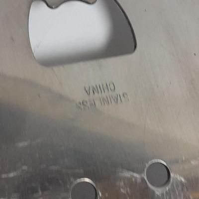 Large stainless steel cooking utensils Barbeque grill or firepit and condiment containers