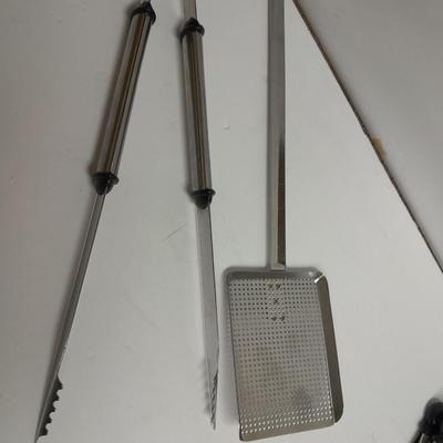 Large stainless steel cooking utensils Barbeque grill or firepit and condiment containers