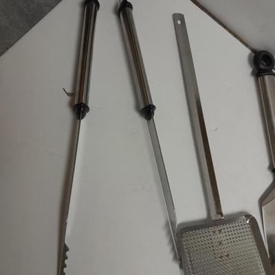 Large stainless steel cooking utensils Barbeque grill or firepit and condiment containers