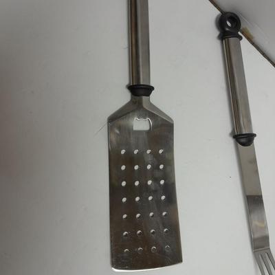 Large stainless steel cooking utensils Barbeque grill or firepit and condiment containers