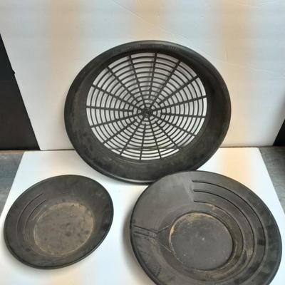 two gold pans and one strainer and a rock pic