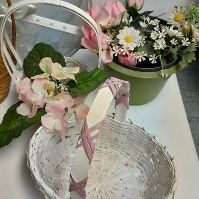 assortment of baskets, pots, bunny statues and faux flowers.