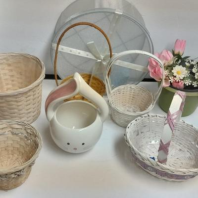 assortment of baskets, pots, bunny statues and faux flowers.