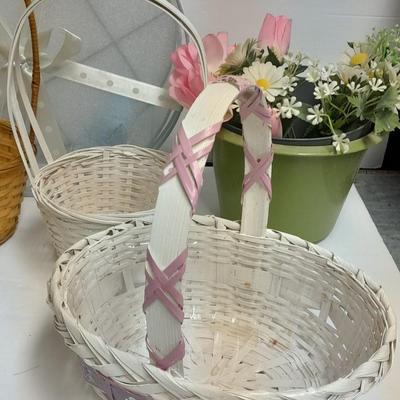 assortment of baskets, pots, bunny statues and faux flowers.
