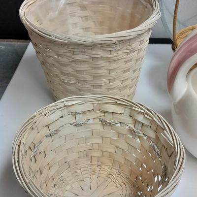 assortment of baskets, pots, bunny statues and faux flowers.