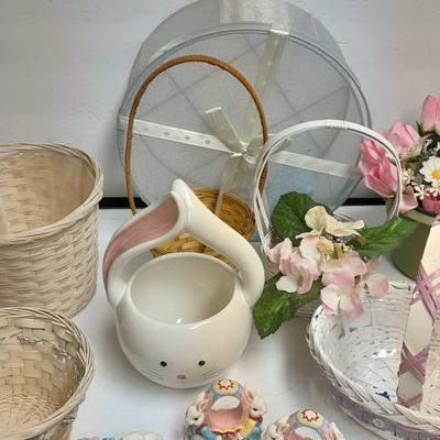 assortment of baskets, pots, bunny statues and faux flowers.