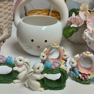 assortment of baskets, pots, bunny statues and faux flowers.
