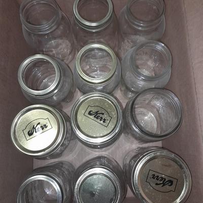 14+ glass canning jars with an assortment of lids