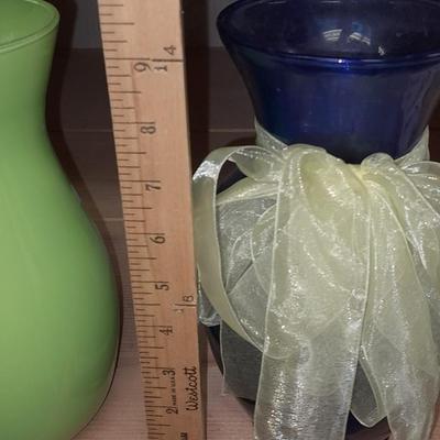 Two glass vases, one green, one blue