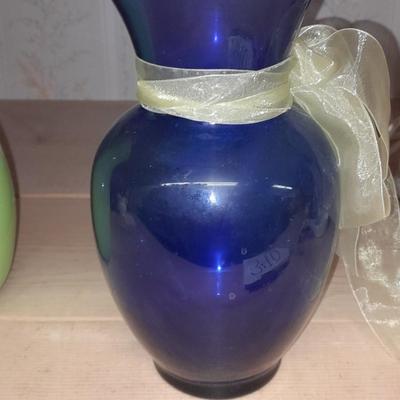 Two glass vases, one green, one blue