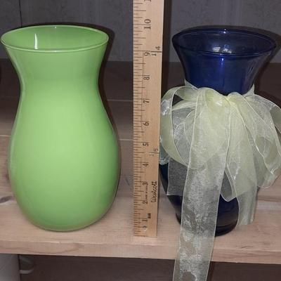 Two glass vases, one green, one blue