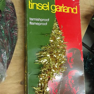 Large light up Christmas star, tree topper, and tinsel Garland