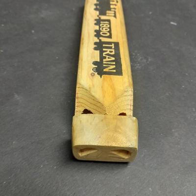 Two wooden train whistles and a vintage metal / tin trombone whistle