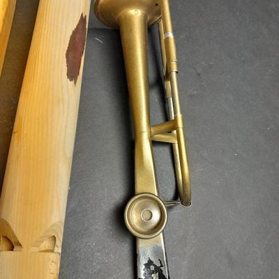 Two wooden train whistles and a vintage metal / tin trombone whistle