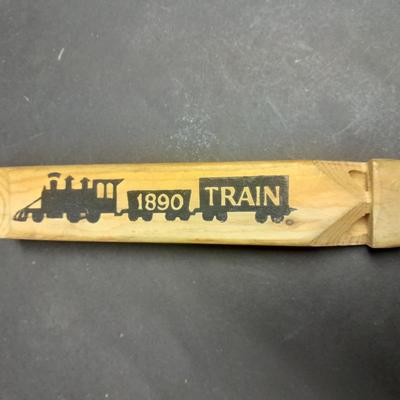 Two wooden train whistles and a vintage metal / tin trombone whistle