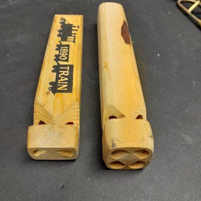 Two wooden train whistles and a vintage metal / tin trombone whistle
