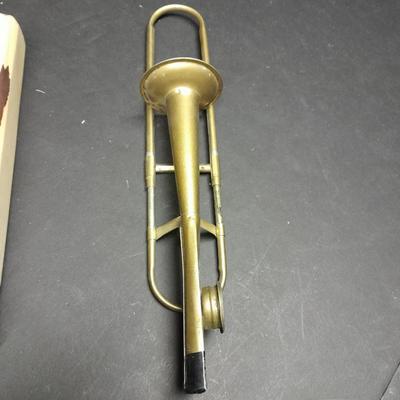 Two wooden train whistles and a vintage metal / tin trombone whistle