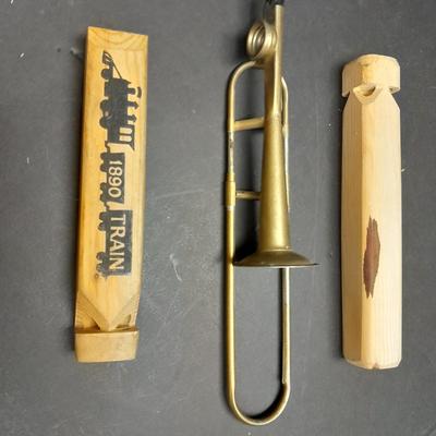 Two wooden train whistles and a vintage metal / tin trombone whistle