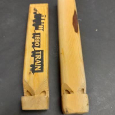 Two wooden train whistles and a vintage metal / tin trombone whistle