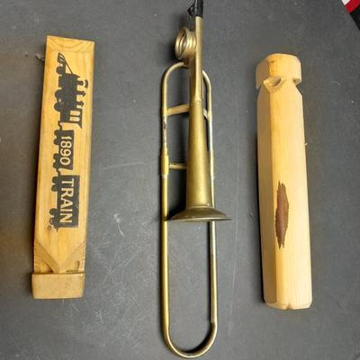 Two wooden train whistles and a vintage metal / tin trombone whistle