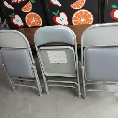 Six foot Long narrow folding buffet table with 4 metal chairs with cushions