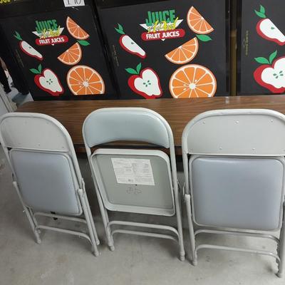 Six foot Long narrow folding buffet table with 4 metal chairs with cushions