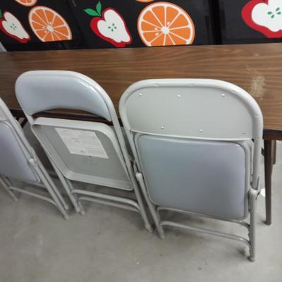 Six foot Long narrow folding buffet table with 4 metal chairs with cushions