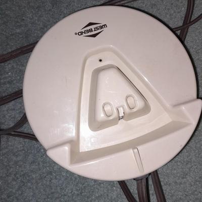 Ironing board with a Westbend power ease cordless Iron and power base charger