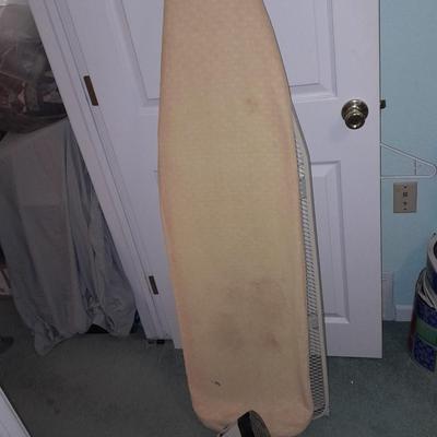 Ironing board with a Westbend power ease cordless Iron and power base charger
