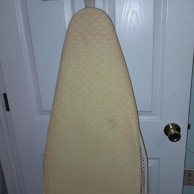 Ironing board with a Westbend power ease cordless Iron and power base charger