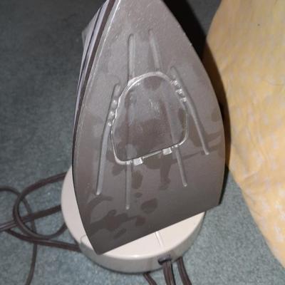 Ironing board with a Westbend power ease cordless Iron and power base charger