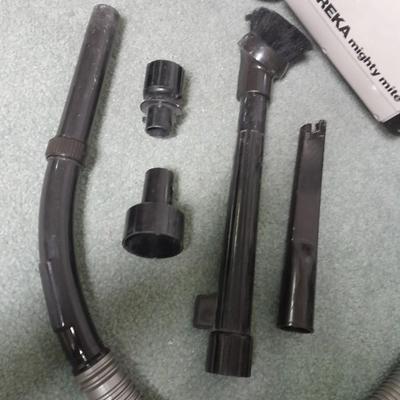 Eureka Mighty Mite canister Vacuum with attachment and extra bags and a cleaning bucket