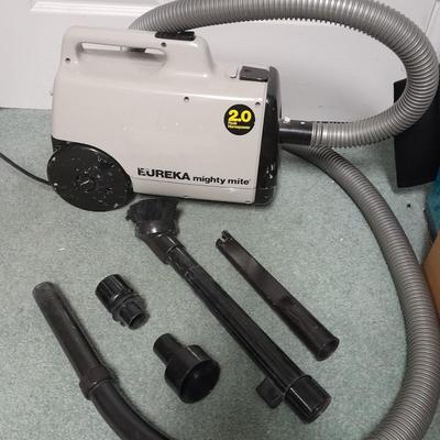 Eureka Mighty Mite canister Vacuum with attachment and extra bags and a cleaning bucket