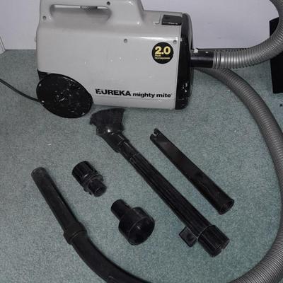 Eureka Mighty Mite canister Vacuum with attachment and extra bags and a cleaning bucket